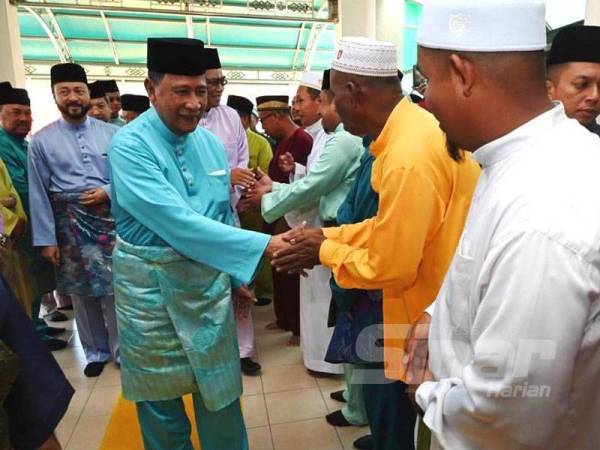 Sultan Sallehuddin bersalaman dengan anak kariah Bukit Larek yang hadir pada majlis perasmian Masjid Al-Ihsan hari ini.