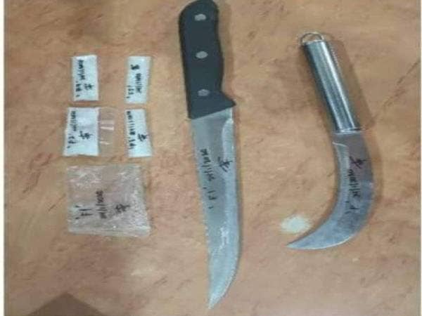 Dua bilah pisau dan dadah yang dirampas daripada suspek dalam serbuan polis di Jalan Siam di sini.