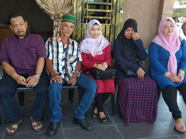 Siti Khairul Nisak (tengah) bersama Abu Hassan (dua dari kiri) dan keluarga angkatnya yang datang ke Kampung Parit Mat Alam, Titi Serong dari Tiram Johor.