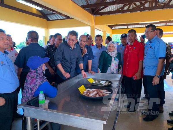 Salahuddin (dua dari kiri) berbual dengan peniaga di Pasar Nelayan Pulau Gajah, Sabak di sini hari ini.