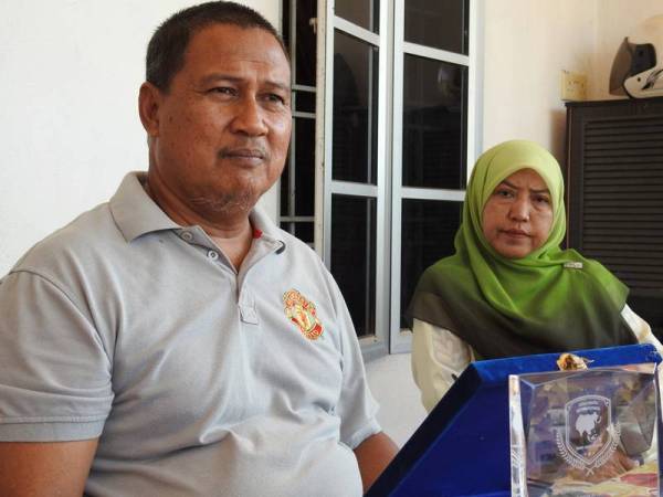 Adanan Long dan Mimi Rohana Amjan, ibu bapa kepada Nurul Atiqah Adanan pelajar Malaysia yang menuntut di Universiti Shandong, China. -Foto Bernama