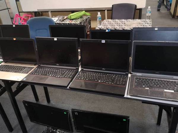 Antara komputer riba yang dirampas dalam operasi tersebut. - Foto ihsan Imigresen