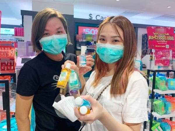 Lee (kiri) ditemui di sebuah farmasi Wangsa Maju sedang membeli bekalan hand sanitizer untuk kegunaan keluarga.