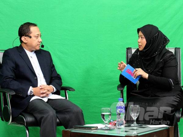 Kamaruzaman (kiri) pada program Sinar Live dengan tajuk 'Kerajaan pintu belakang, apa kata Pas' di Shah Alam hari ini.