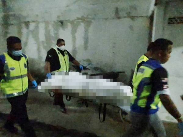Anggota polis mengusung mayat mangsa.