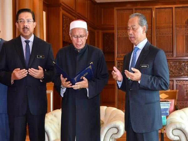 Muhyiddin (kanan) mengaminkan doa yang dibacakan Dr Zulkifli semasa menerima kunjungan Mufti Wilayah Persekutuan itu di Bangunan Perdana Putra hari ini. Turut kelihatan, Ketua Setiausaha Negara Datuk Seri Mohd Zuki Ali (kiri). - Foto Bernama