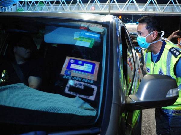 Timbalan Ketua Polis Jabatan Siasatan Jenayah (Risikan dan Operasi) Ibu Pejabat Polis Kontinjen Selangor, ACP Zaldino Zaludin (kanan) menasihatkan pengguna jalan raya supaya mengambil serius tindakan kerajaan atas pelaksanaan Perintah Kawalan Pergerakan yang bermula hari ini sehingga 31 Mac sebagai langkah mengekang penularan jangkitan COVID-19 ketika Ops COVID-19 di Jalan Khoo Kai Kim, malam ini. - Foto Bernama