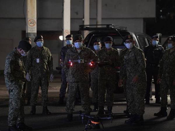 Panglima Tentera Darat (PTD) Jeneral Tan Sri Ahmad Hasbullah Mohd Nawawi (tengah) melihat ke arah dron yang sedang mendarat ketika melakukan tinjauan penggunaan dron oleh Angkatan Tentera Malaysia dalam tugasan OP Penawar di sekitar ibu kota hari ini. - Foto Bernama