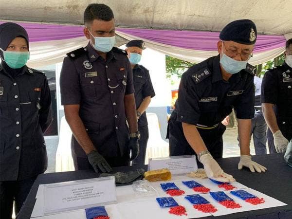 Hasanuddin (kanan) menunjukkan pil kuda yang dirampas.