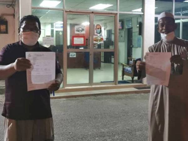 Ahmad Mustain (kiri) dan pengusaha biskut raya membuat laporan polis di Balai Polis Sabak Bernam, semalam.