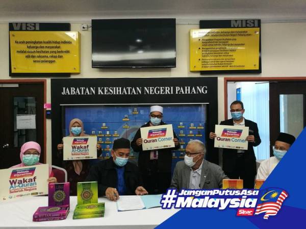 Md Abdu menandatangani surat penyerahan sumbangan Projek Wakaf Al-Quran disaksikan Dr Bahari di Pejabat JKN Pahang, Indera Mahkota semalam. 