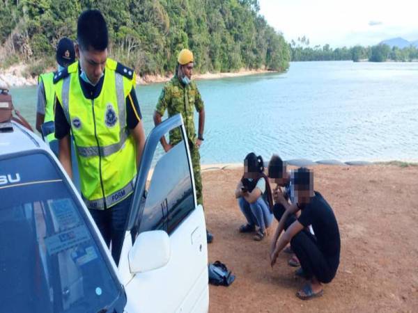 Remaja perempuan bersama dua rakan lelakinya ditahan ketika sedang makan angin di Pantai Bukit Keluang, di sini petang kelmarin. Foto: Ihsan IPD Besut