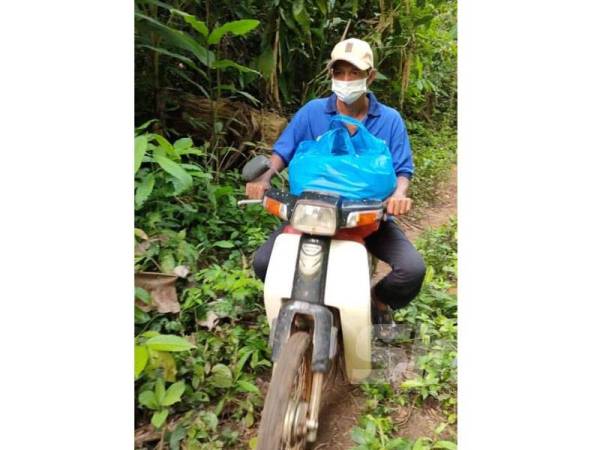 Cikgu Mie agih bantuan kepada Orang Asli menggunakan motor kapcai sahaja.