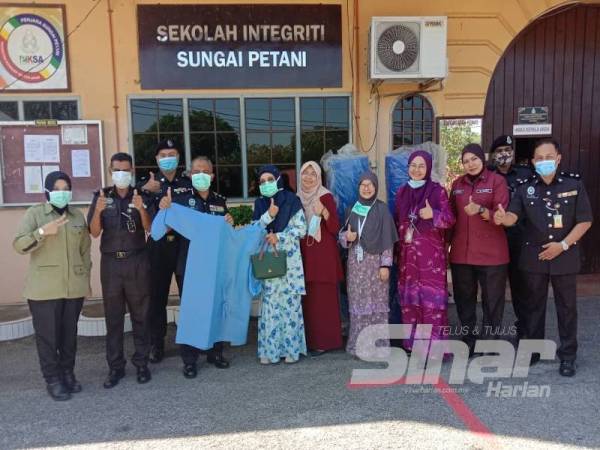 Kakitangan Penjara Sungai Petani menunjukkan PPE yang dihasilkan.