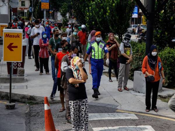 Orang ramai beratur dan mematuhi arahan dengan menjarakkan diri satu meter bagi mencegah penularan Covid-19 ketika membeli barangan basah di Pasar Borong Chow Kit, Kuala Lumpur semalam.