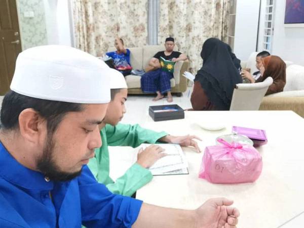 Mohd Khairul Azman (kiri) bersama anak- anak dan ahli keluarga akan bertadarus satu juzuk selepas solat Subuh pada setiap hari.