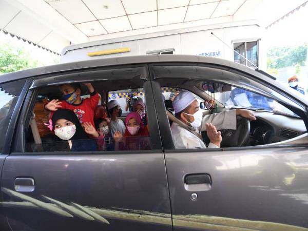 Adnan Abd Wahab, bersama isteri Nur Izyani Johari, dan tujuh anak, yang berumur antara satu hingga 13 tahun, keluar dari pusat kuarantin di Hotel Seri Malaysia setelah menjalani kuarantin wajib selama 14 hari selepas pulang dari Thailand. -Foto Bernama