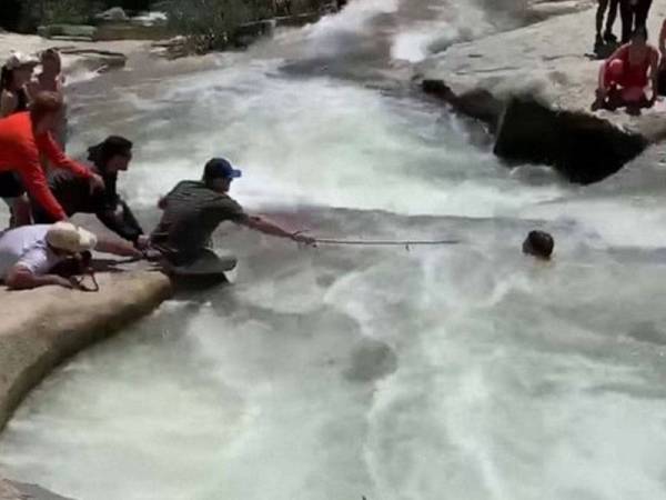 Brent (depan) menyelamatkan Fresno yang terperangkap di arus deras. - Foto ABC News
