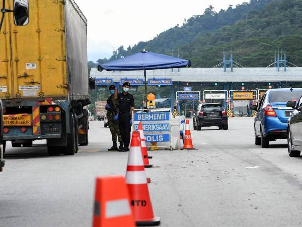 Anggota Polis dan Tentera mengawal aliran trafik di Plaza Tol Gombak menghala ke Pantai Timur ekoran sekatan jalan raya hari ini. - Foto Bernama