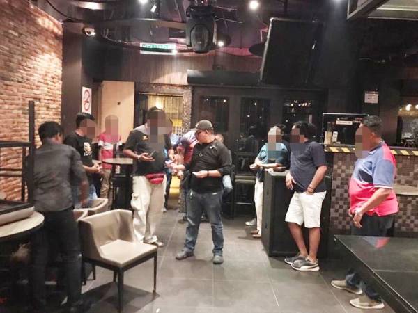 Seramai 12 lelaki ditahan sedang berhibur di sebuah pusat hiburan di Ipoh. - Foto PDRM