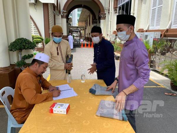 Makmum yang hadir perlu mendaftarkan diri dan memeriksa suhu badan sebelum ke bahagian sanitasi dan dibenarkan masuk ke dalam masjid. 