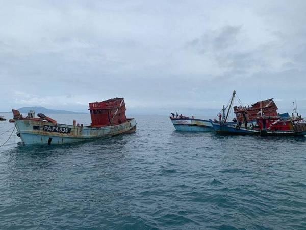 Bot yang menjalankan operasi penenggelaman (kanan) menghampiri salah satu bot nelayan asing untuk melakukan prosedur yang sepatutnya.
