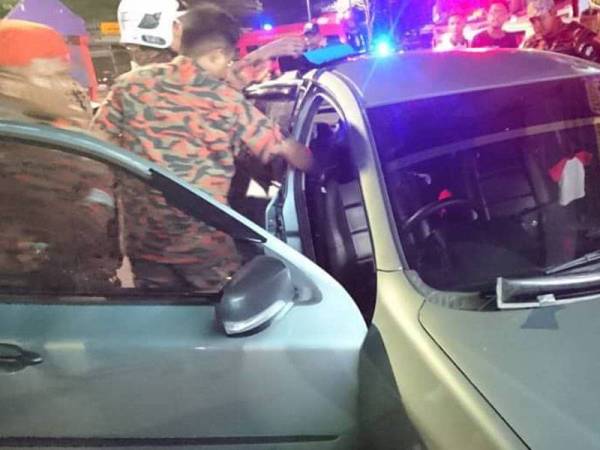 Anggota bomba menyelamatkan kanak-kanak perempuan yang terperangkap dalam kereta di Taman Indah Muar di sini malam tadi.