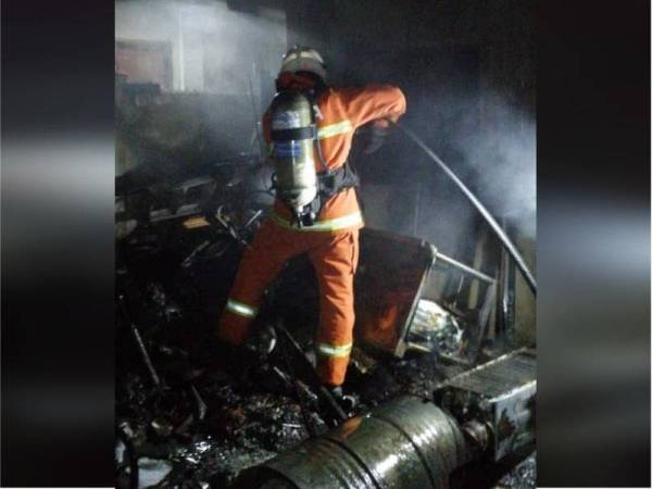 Anggota bomba memadamkan kebakaran di Taman Seri Kota, Jalan Kuala Kedah pagi tadi.