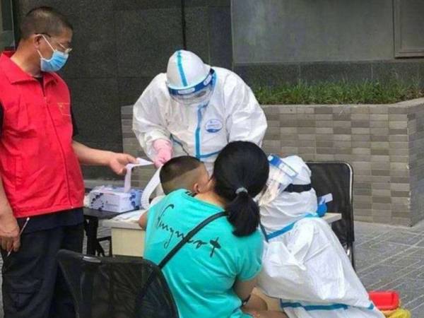 Kanak-kanak menjalani saringan kesihatan. - Foto Mirror.UK