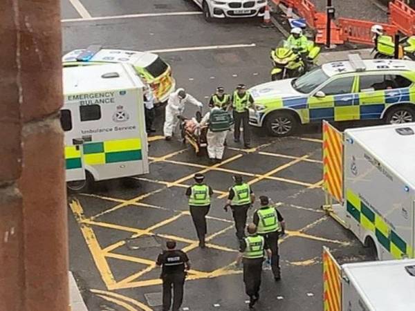 Anggota paramedik membantu mangsa yang cedera dalam kejadian serangan di Park Inn Hotel tersebut. - Foto: Agensi