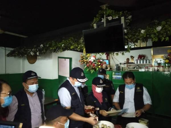 Sze Han (tiga dari kanan) meninjau salah sebuah premis sewaktu operasi berkenaan.