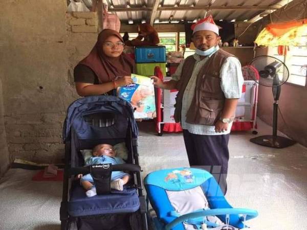 Siti Nor Farhanis menerima sumbangan daripada ADUN Tahan, Mohd Zakhwan Ahmad Badarddin yang menziarahi keluarganya di Kampung Paya Garok, Jerantut.