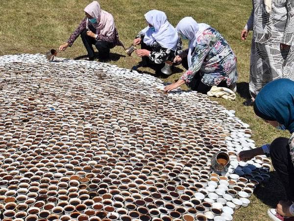 Beberapa wanita membantu artis Bosnia, Aida Sehovic menyiapkan hasil seni terdiri daripada 8,000 cawan kopi digelar 'Why Aren't You Here' sebagai simbol memperingati 8,000 Muslim yang menjadi mangsa pembunuhan kejam pada 1995. - Foto: AFP