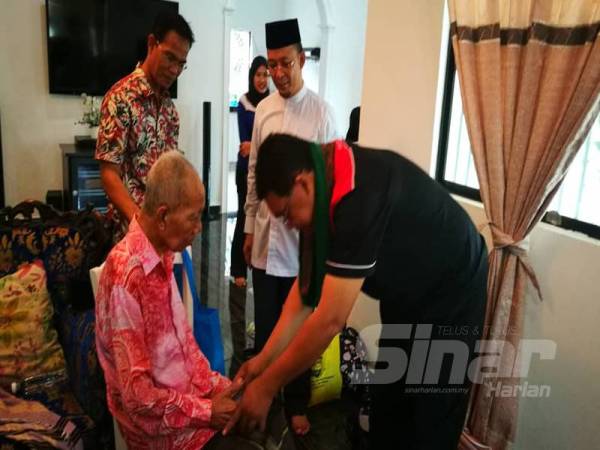 Dr Baharudin (kanan) ketika menyampaikan sumbangan kepada Jamali. 