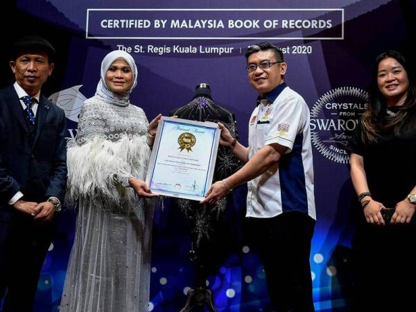 Pengarah Pemasaran Bawal Exclusive Sdn Bhd Haliza Maysuri (dua, kiri) menerima sijil pengiktirafan dari Malaysia Book of Records (MBOR) daripada Ketua Pegawai Operasi MBOR Christopher Wong (dua, kanan) ketika Majlis Pengumuman Bawal Exclusive mempersembahkan tudung termahal di dunia bertatahkan kristal Swarovski hari ini.