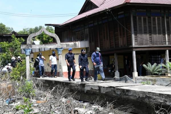 Surina Saad (dua dari kanan) bersama pegawainya ketika memantau di sekitar perkampungan nelayan Pulau Ketam, Kuala Perlis semalam. FOTO: BERNAMA 