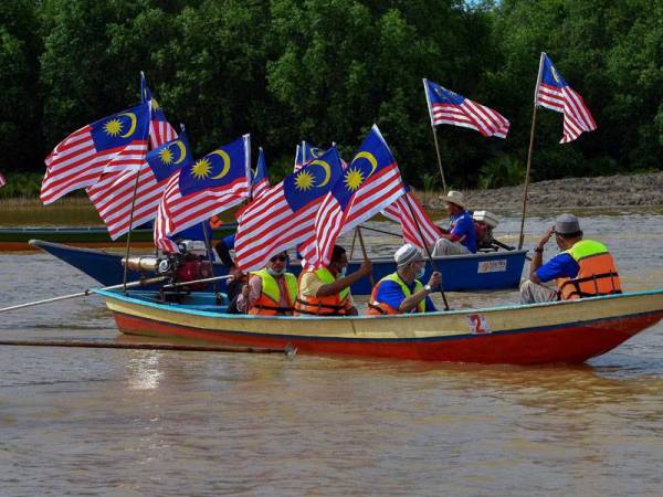 Sebahagian 150 peserta berarak megah dengan 26 buah bot nelayan dari Pantai Ndo ke Pulau Teluk Rejuna dengan mengibarkan Jalur Gemilang bagi meraikan Hari Kebangsaan ke-63 pada Majlis Sambutan Bulan Kebangsaan dan Hari Malaysia 2020 hari ini. - Foto Bernama
