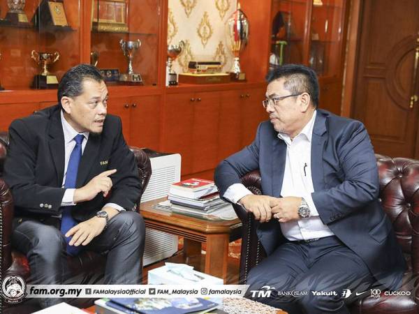 Sulaiman (kanan) berkata sesuatu kepada Hamidin di Wisma FAM, Kelana Jaya hari ini.