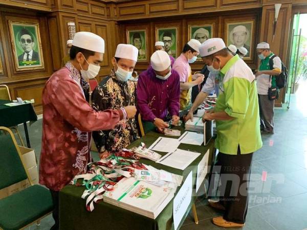 Perwakilan mendaftar dan melakukan pemeriksaan suhu badan sebelum dibenarkan masuk dewan utama.