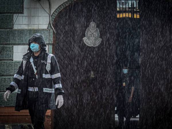 Kakitangan penjara mengawal pintu keadaan sekitar kawasan pintu masuk Penjara Reman Pulau Pinang hari ini. - Foto Bernama