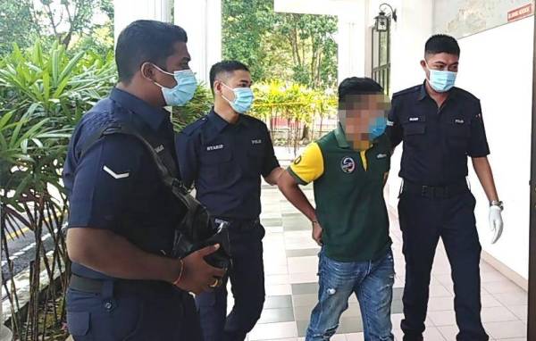 Tertuduh dibawa anggota polis ketika di Mahkamah Majistret Kulim hari ini.