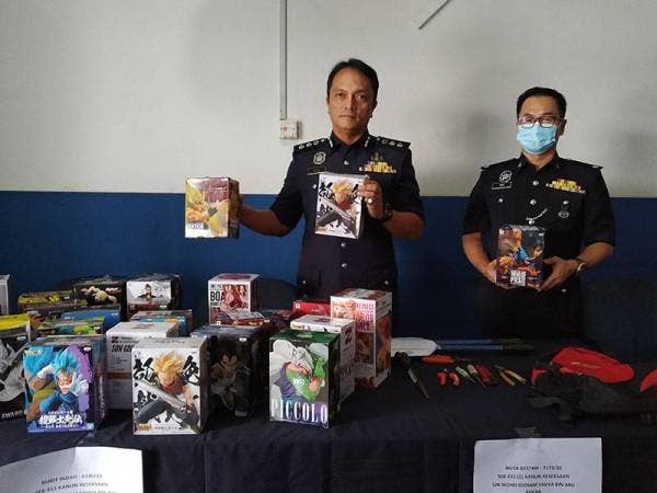 Dzulkhairi menunjukkan figura adiwira yang dirampas daripada suspek pada sidang akhbar di IPD Iskandar Puteri hari ini.