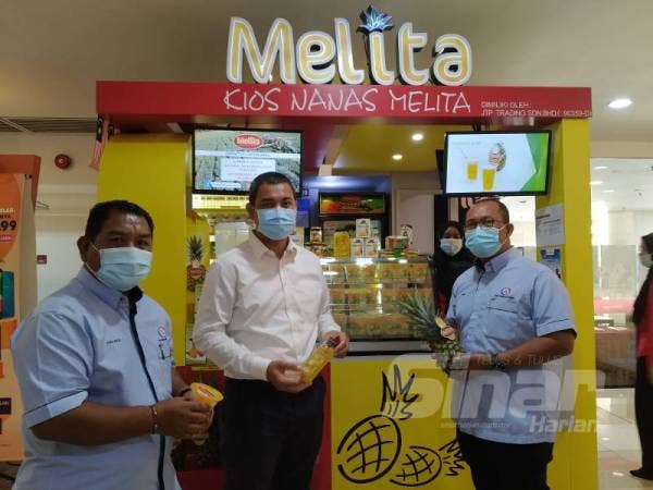 Dr Sahruddin (tengah) dan Mohamad Yami (kiri) melihat produk yang dijual di kios Melita di Galleria@Kotaraya, Johor Bahru. 