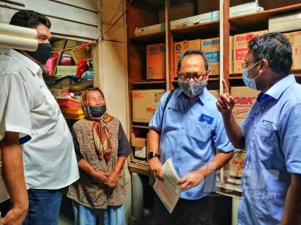 Nazir Hussin (kanan) meninjau keadaan rumah Mardziah yang kerap dilanda banjir kilat.