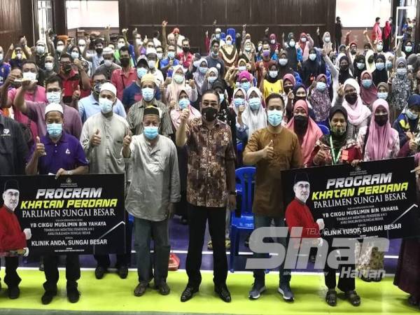 Muslimin (tengah) bergambar bersama jawatankuasa dan ibu bapa yang mewakili anak-anak pada Majlis Penyerahan Kupon Berkhatan di Dewan Sri Bernam hari ini.