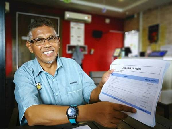 Hanafiah menunjukkan anggaran kos pembinaan projek pembentung bagi mengatasi masalah banjir di Teluk Kalong, Kemaman.