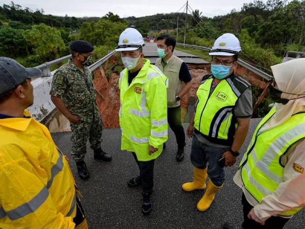 Fadillah bersama beberapa pegawai dari Jabatan Kerja Raya membuat tinjauan ke lokasi kejadian jambatan runtuh di Jalan Lechar Dong, Raub pada Rabu. Foto Bernama