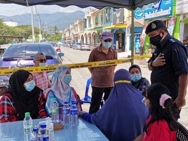 A Asmadi (kanan) bertemu dengan keluarga mangsa yang berada di pos kawalan tempat kejadian pada Jumaat.
