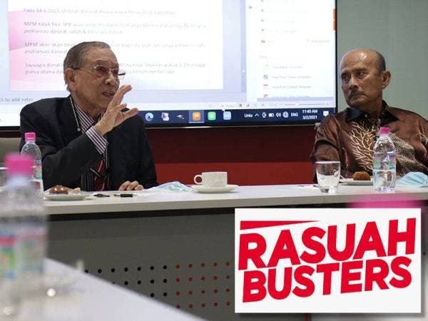 Tan Sri Abu Zahar Ujang (kanan) diperhatikan oleh bekas Ketua Polis Negara, Tun Mohammed Hanif Omar ketika hadir di Kumpulan Karangkraf, Shah Alam, Selangor pada Rabu.