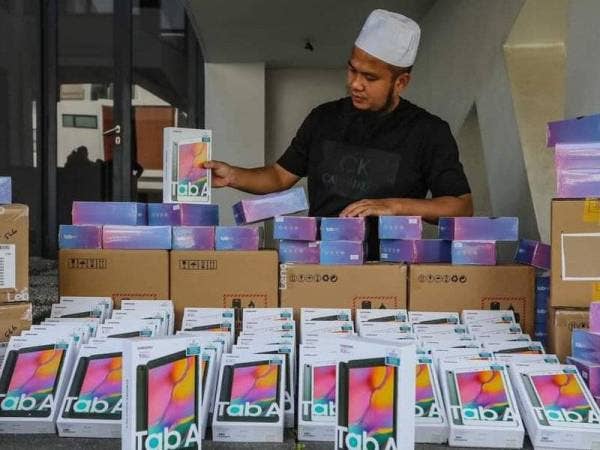 Ebit Lew bersama gajet yang dibelinya dengan menggunakan wang sumbangan TMJ bagi membantu pelajar menjalani sesi PdPR ekoran penularan Covid-19.